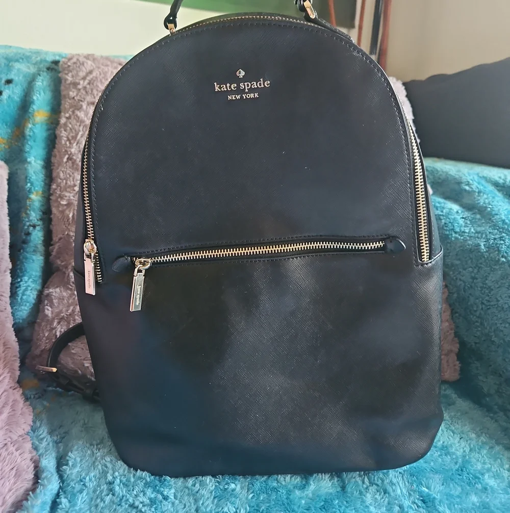 AS-IS Kate Spade black leather backpack LEFT STRAP AT THE TOP TORN. STILL NEW
